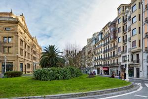 a city street with tall buildings and a green park at Eki Terrace by FeelFree Rentals in Donostia-San Sebastián