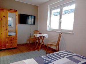 a bedroom with a bed and a table and a window at FeWo-Haus-Junkernhof in Medebach