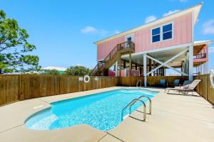 a swimming pool in front of a house at Ocean Overlook in Gulf Shores