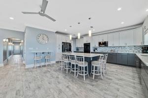 a kitchen with a counter and a clock on the wall at Ocean Overlook in Gulf Shores