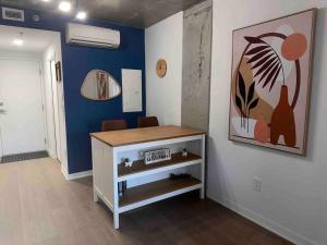 a room with a desk and a painting on the wall at Bel Appartement au centre-ville Montréal in Montreal