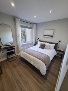 a bedroom with a large bed and a window at The Cove Apartment, Portstewart near Prom, Parking in Portstewart