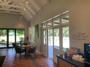 a kitchen with a table and chairs and a dining room at Lynx Wine Estate in Franschhoek