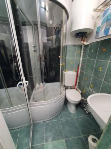 a bathroom with a toilet and a tub and a sink at CHIC APARTMENT- Place to Remember in Galaţi