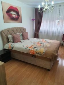 a bedroom with a bed with a red lips at CHIC APARTMENT- Place to Remember in Galaţi