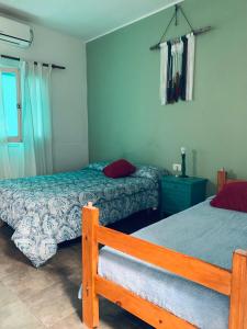 a bedroom with two beds and a window at Hostel Casa Blanca in San Luis