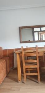 una mesa de madera con 2 sillas y un espejo en Casa Telares Ávila, en Ávila