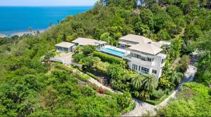 an aerial view of a house on a hill with the ocean at Baan Fhan Talay in Laem Set Beach