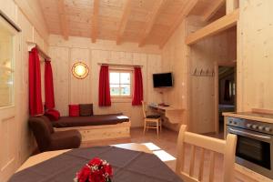 a small living room with a couch and a table at Alpenchalets Hotel Lambach in Seebruck