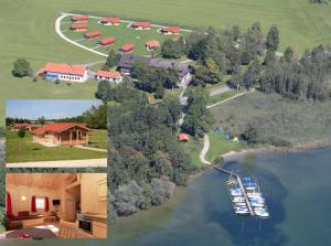 - une vue aérienne sur une maison et une rivière avec des bateaux dans l'établissement Alpenchalets Hotel Lambach, à Seeon-Seebruc