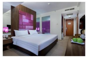 Ένα ή περισσότερα κρεβάτια σε δωμάτιο στο Quest Hotel Darmo - Surabaya by ASTON