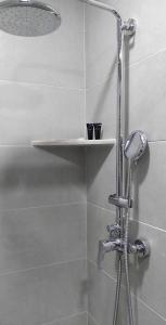 a shower with a shelf in a bathroom at Crystal Wood Apartment 213 in Bakuriani