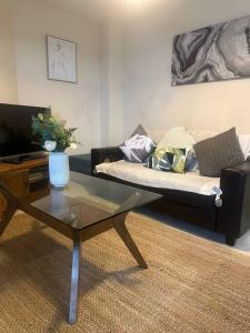 a living room with a couch and a coffee table at The Raleigh Apartment Central Plymouth 2 Bedroom in Plymouth