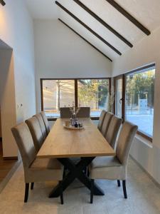 a dining room with a wooden table and chairs at WoodAvenue in Blidinje