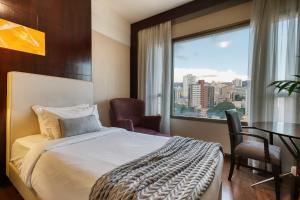 Cama ou camas em um quarto em Mercure Belo Horizonte Lourdes