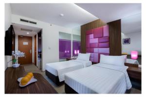 Ένα ή περισσότερα κρεβάτια σε δωμάτιο στο Quest Hotel Darmo - Surabaya by ASTON