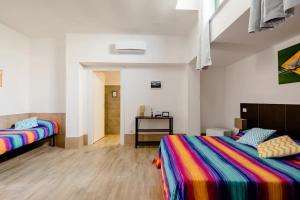 A bed or beds in a room at L'ANFORA DELLE MURELLE