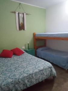 a bedroom with a bed and a bunk bed at Hostel Casa Blanca in San Luis
