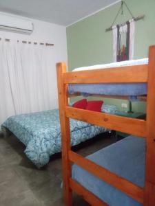 a bedroom with two bunk beds and a bed at Hostel Casa Blanca in San Luis