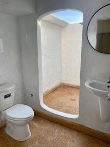 a bathroom with a toilet and a sink and a mirror at Rocky resort in Koh Tao