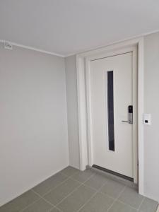 an empty room with a white door with a picture at Leilighet in Porsgrunn