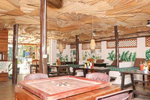 a restaurant with a pool table in the middle of a room at Popoyo Surf Resort in Arugam Bay