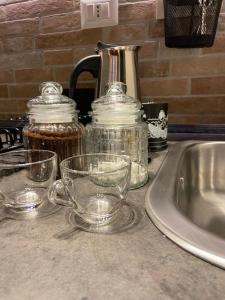 a kitchen counter with glass dishes and a sink at Dimora del Papa - terrazza in Rome