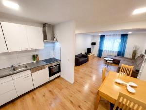a kitchen and living room with a table and a dining room at Haus am See in Heddesheim