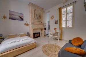 a bedroom with a large bed and a fireplace at Charming hypercentre apartment Bordeaux in Bordeaux
