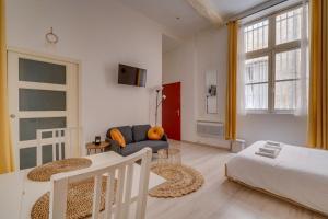 a living room with a bed and a couch at Charming hypercentre apartment Bordeaux in Bordeaux