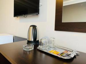 a tray with glasses and a coffee maker on a table at ANİMOS BUTİK OTEL in Ankara