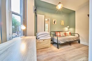 a bedroom with a bed and a window at Belfry House in Bristol