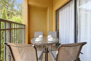 a table and two chairs on a balcony at International Drive Luxury Condo in Orlando