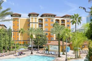 a view of a hotel with a pool and palm trees at International Drive Luxury Condo in Orlando