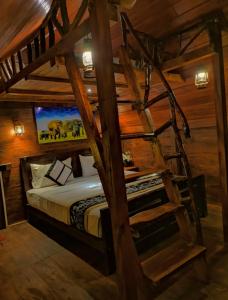 a bunk bed in a room with a tv at Levona Garden Resort in Habarana