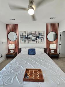 a bedroom with a large white bed with two mirrors at Dallas Luxury Modern House By Dallas Love Airport in Dallas