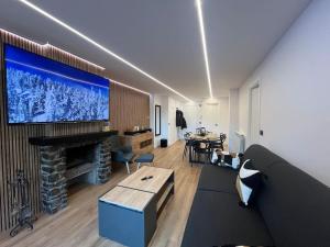 a living room with a large tv on the wall at 6. APT Encantador en Arinsal in Arinsal