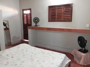 a bedroom with a bed and a window at Hospedagem da Keila Matos in Aracati +7 photos
