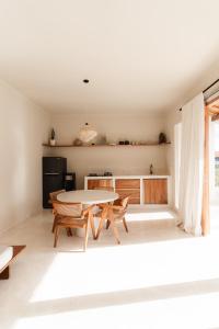 a kitchen with a table and chairs in a room at Villa FES 2 Bedrooms Private Villa 5mins Beach in Munggu