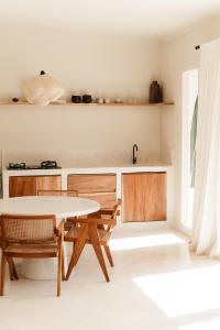 a kitchen with a table and chairs in a room at Villa FES 2 Bedrooms Private Villa 5mins Beach in Munggu