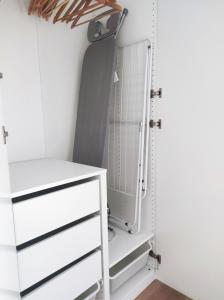 a closet with a white dresser and a shelf at JAPANDI Apartament Modlińska Żerań in Warsaw