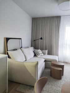 a living room with a couch and a bed at JAPANDI Apartament Modlińska Żerań in Warsaw