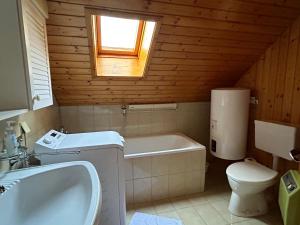 a bathroom with a tub and a toilet and a sink at WIEDWEG GOLD in Wiedweg +48 photos