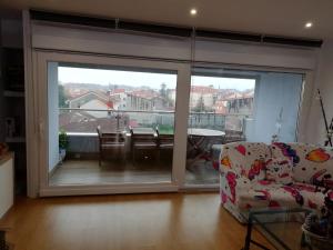 a living room with a large sliding glass door at El mirador de Mila II en el corazón del Salnes VUT-PO-14731 in Cambados