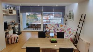 a living room with a table and a couch at El mirador de Mila II en el corazón del Salnes VUT-PO-14731 in Cambados