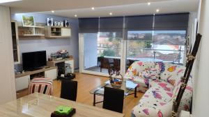 a living room with a couch and a table at El mirador de Mila II en el corazón del Salnes VUT-PO-14731 in Cambados