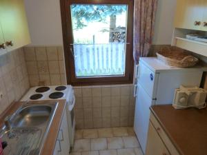 a kitchen with a sink and a stove and a window at Ferienhaus mit Kamin , Terrasse und Aussensauna in Pöhla +36 photos