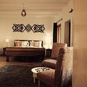 a bedroom with a bed and a chair at Les Dunes de Dakhla in Dakhla