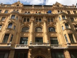 a large yellow building with windows and balconies at Perfect Day 3 -3 bedr, 2 bathrooms in Budapest