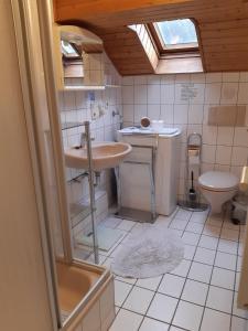 a bathroom with a sink and a toilet at Ferienwohnung Breuer 